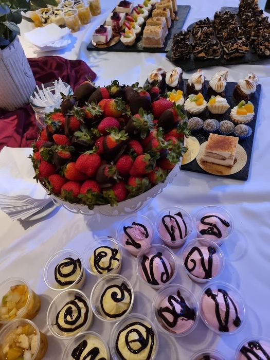 Mesa dulce con frutillas bañadas en chocolate y postres